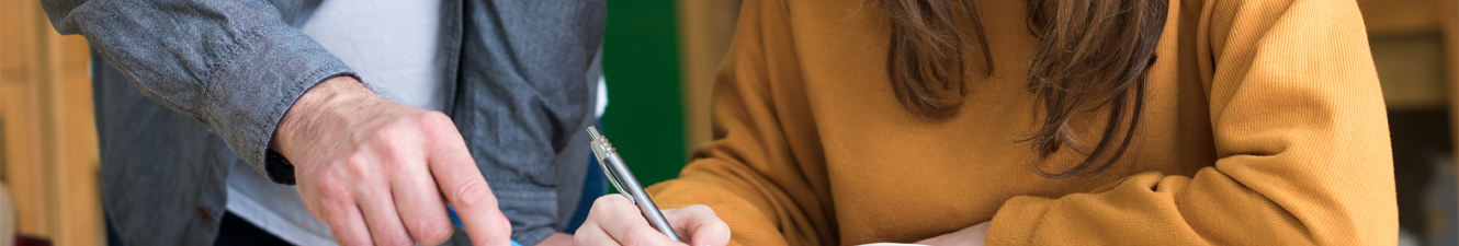 guy and girl with pencils in hand